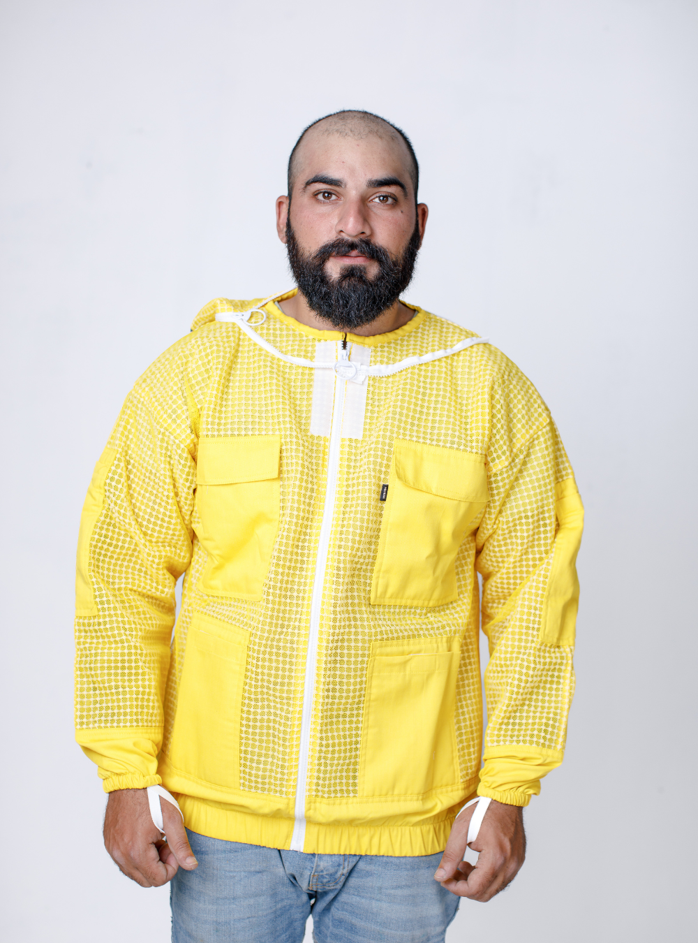 Man wearing a Golden Hive Guardian Beekeeping Jacket for beekeeping, with a detachable Fencing Veil and ample storage pockets.