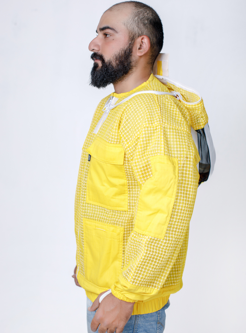 A side look Golden Hive Guardian Beekeeping Jacket for beekeeping, with a detachable Fencing Veil and ample storage pockets.