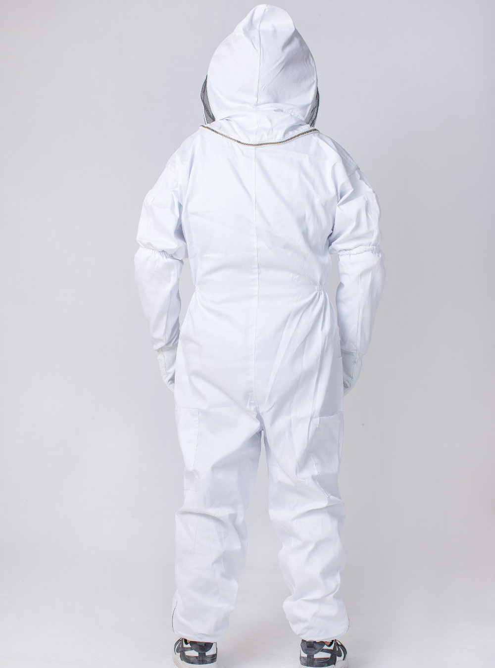 Beekeeper in a WhiteGuard Fencing Beekeeper Suit, crafted from high-quality cotton for durability, complete with a round fencing veil for face protection Back look.