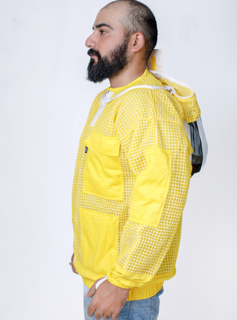 A side profile of Yellow Beekeeping Ventilated Jacket featuring a detachable Fencing veil and elastic comfy cuffs.